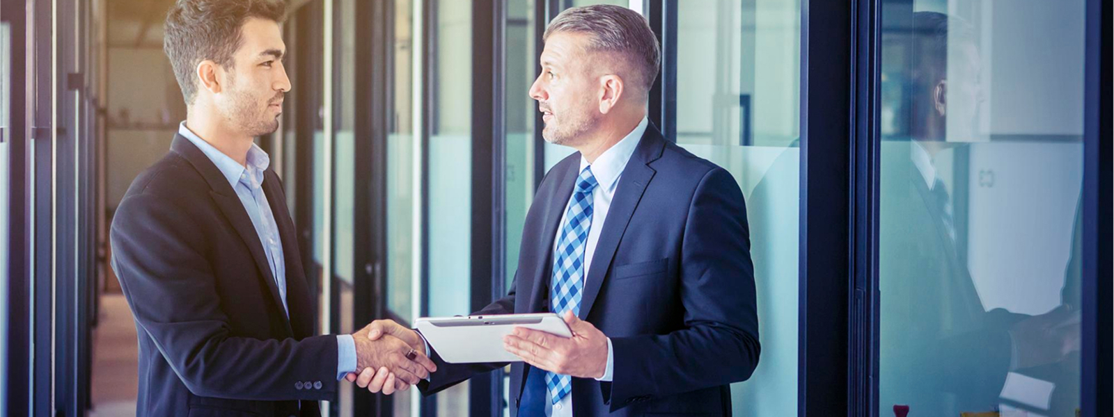 Businesspeople shaking hands, symbolizing a successful outsourcing partnership that drives growth