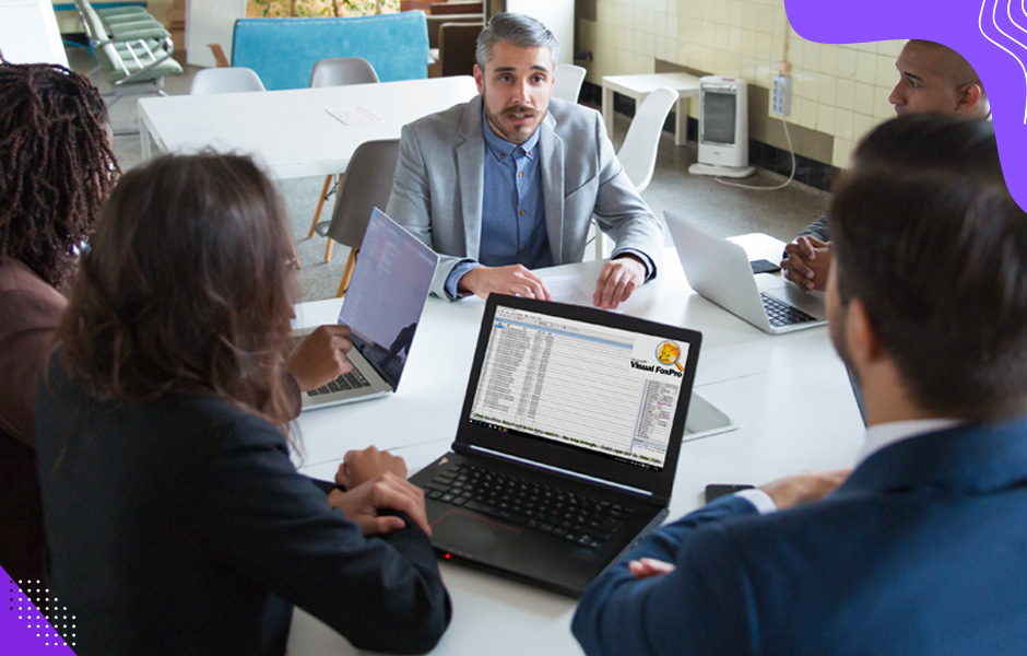 Business leaders discuss migrating a visual foxpro system to leverage cloud capabilities in a boardroom meeting.