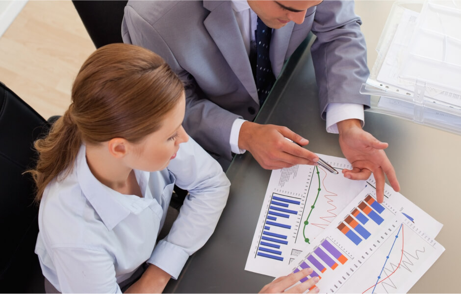 Manager reviewing metrics for reduced costs through partnering with Java developers on customized Java solutions.
