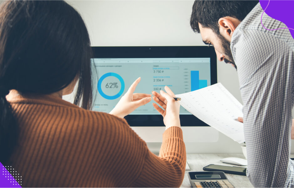 A developer shows metrics on a screen proving Python adoption success to a software development company executive.