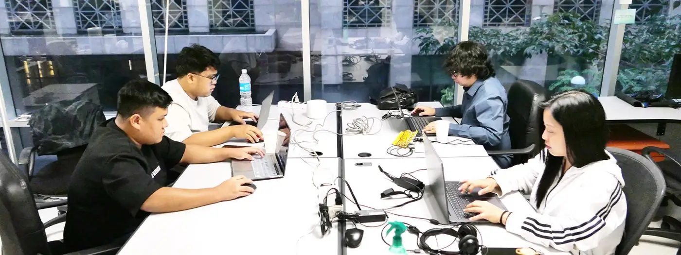 Microsoft access programmers brainstorm around a whiteboard with notes and diagrams related to custom database solutions.